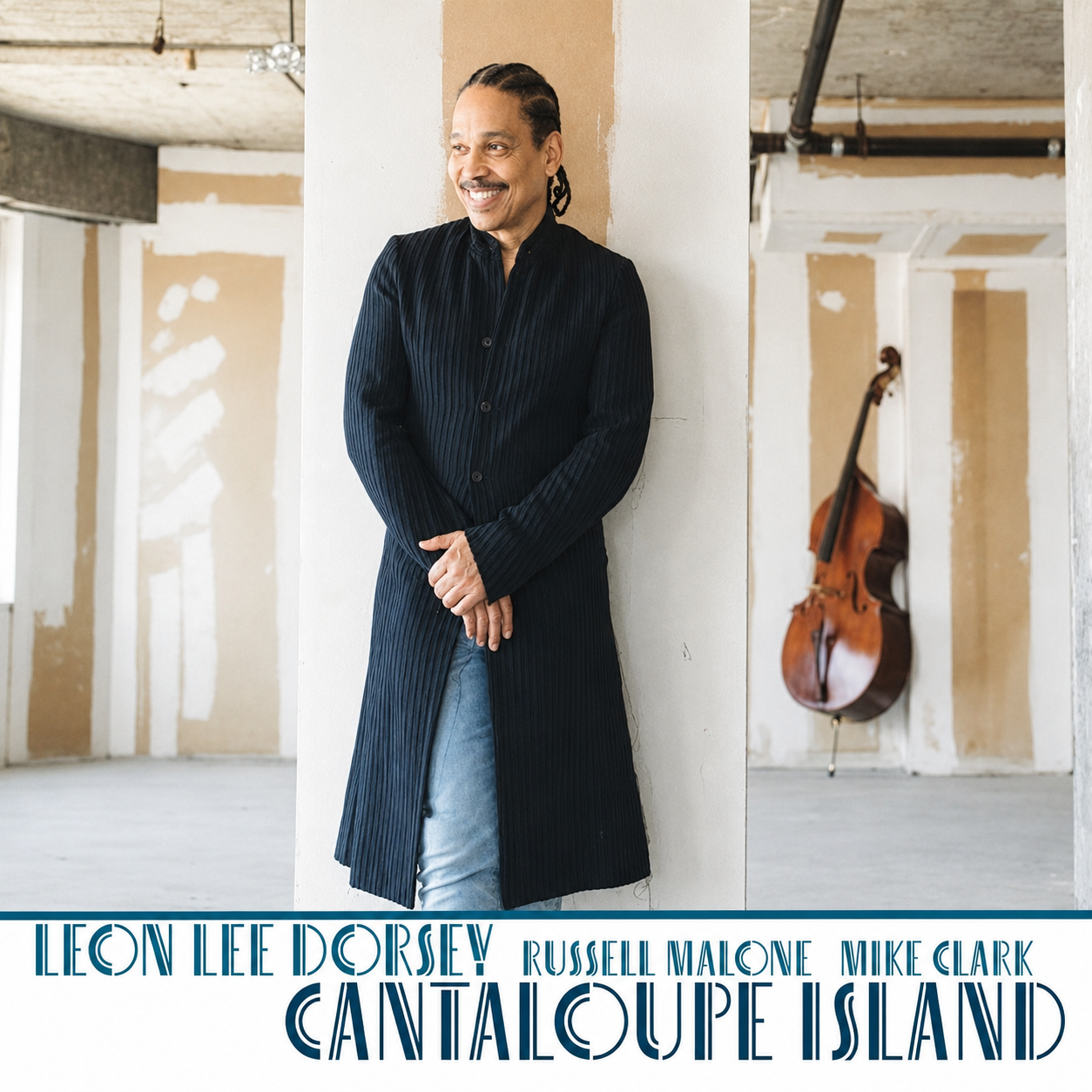 A man in a long black coat standing against a white wall in an interior space with exposed ceiling and pipework, and a cello hanging on the wall behind him. The image promotes Leon Lee Dorsey's album 'Cantaloupe Island' with artists Russell Malone and Mike Clark.